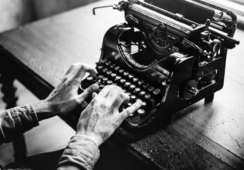 Typewriter and hands writing. Illustration photo.