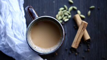 A cup of tea and cinnamon sticks. Photo