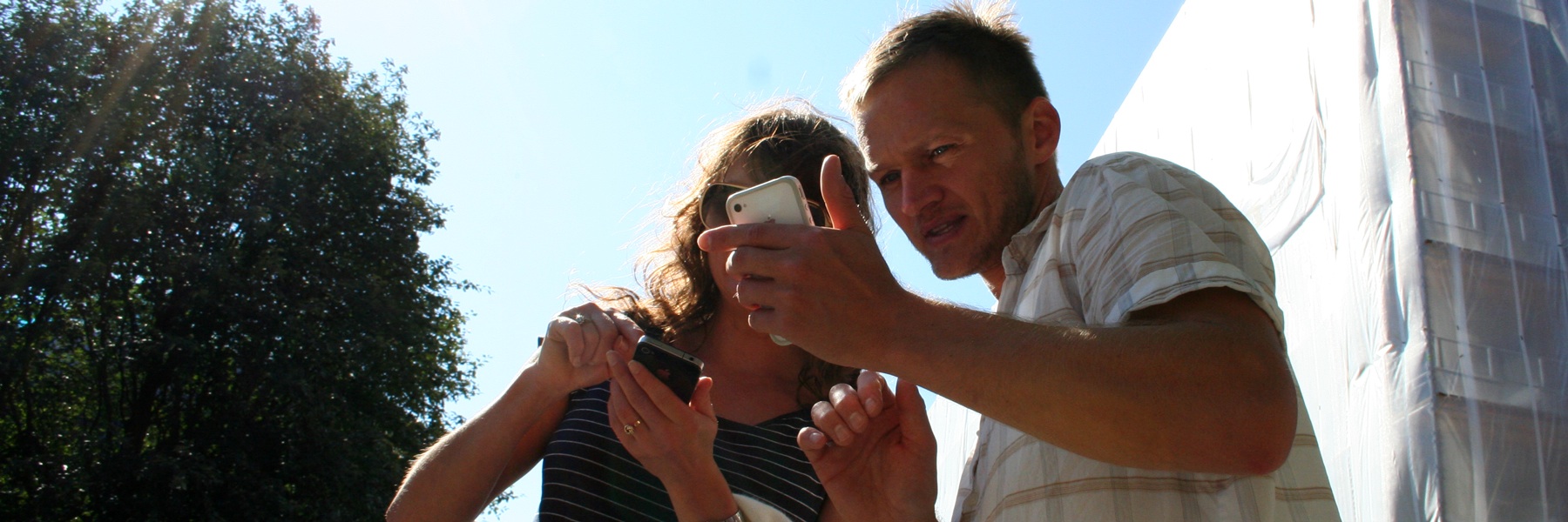 Two people looking at a mobile phone