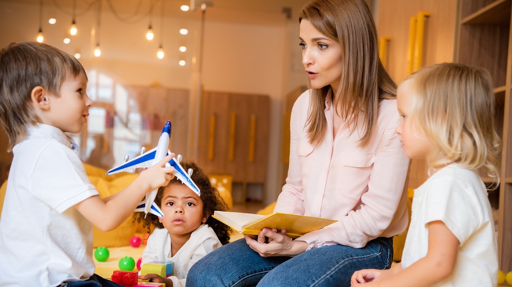 kindergarten teacher talking with kindergarten children