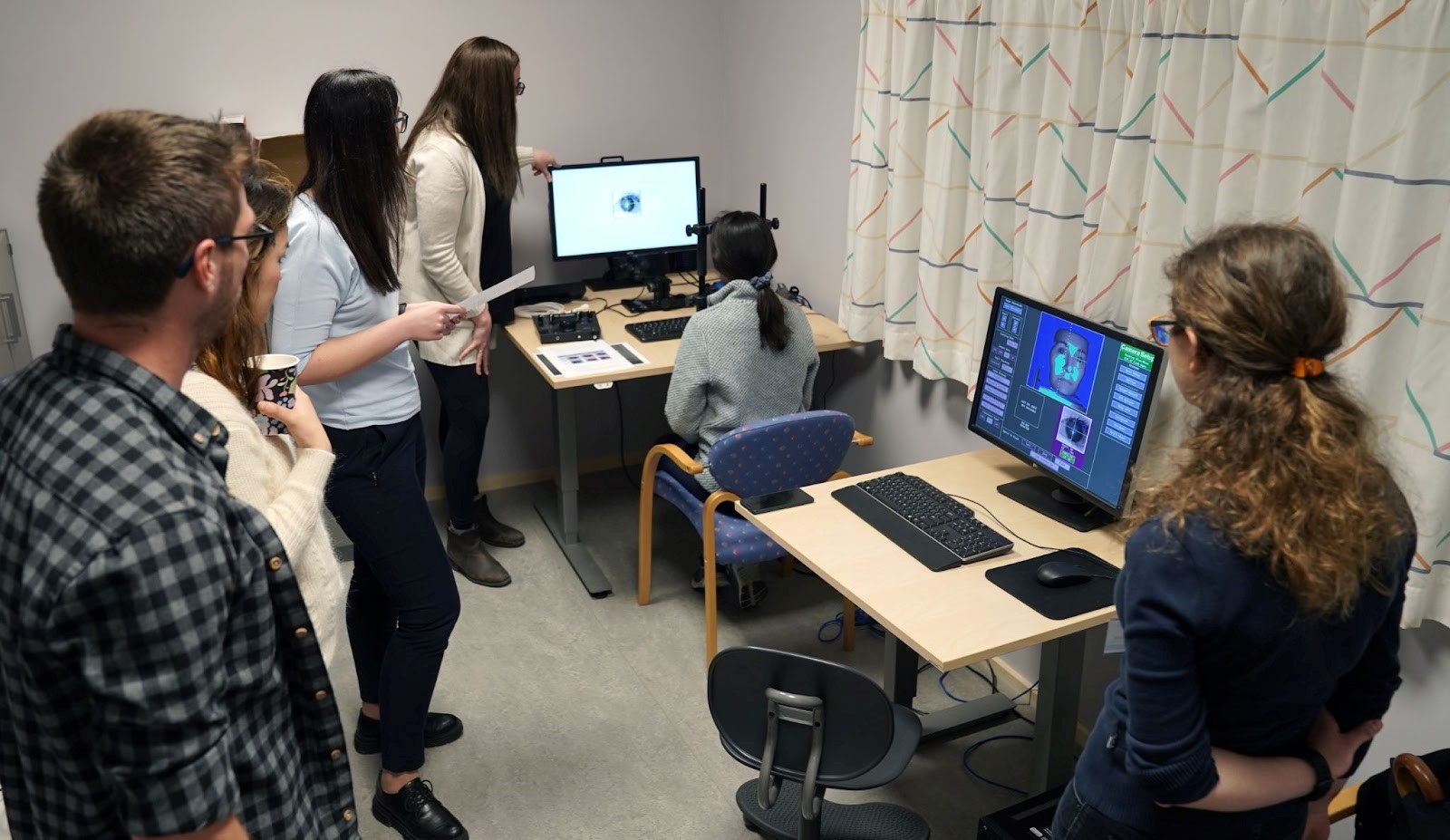 Angeliki Altani demonstrating eye tracking equipement during hands-on training