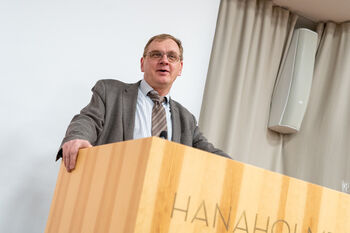 Glasses ,Microphone ,Podium ,Lectern ,Tie.
