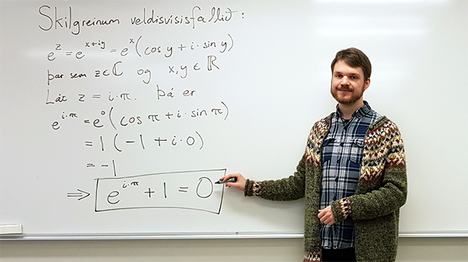 Jóhann Örn Sigurjónsson in front of a white board with a mathematics formula